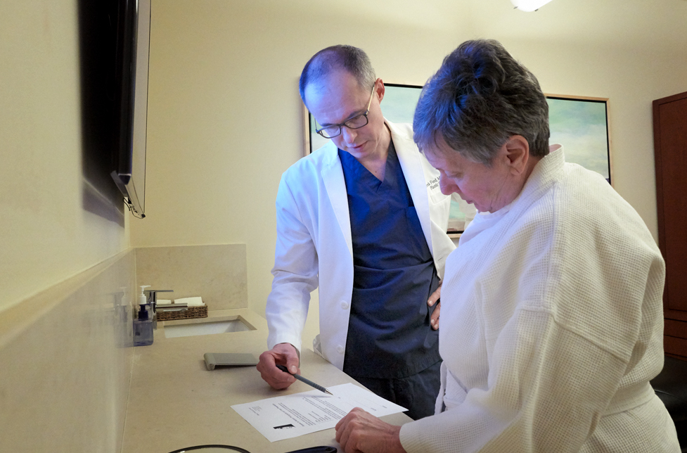 Doctor Ford reviewing paperwork with patient