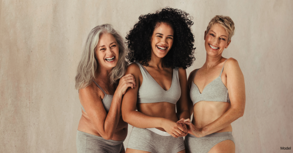 Three women embracing each other and smiling at the camera (models)