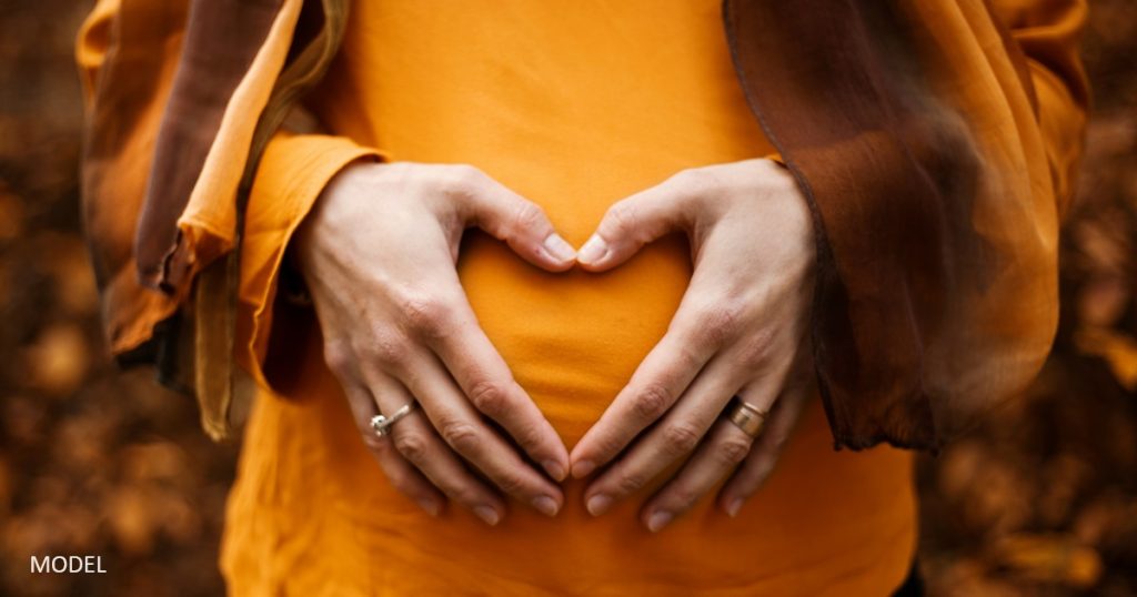 woman holding pregnant belly