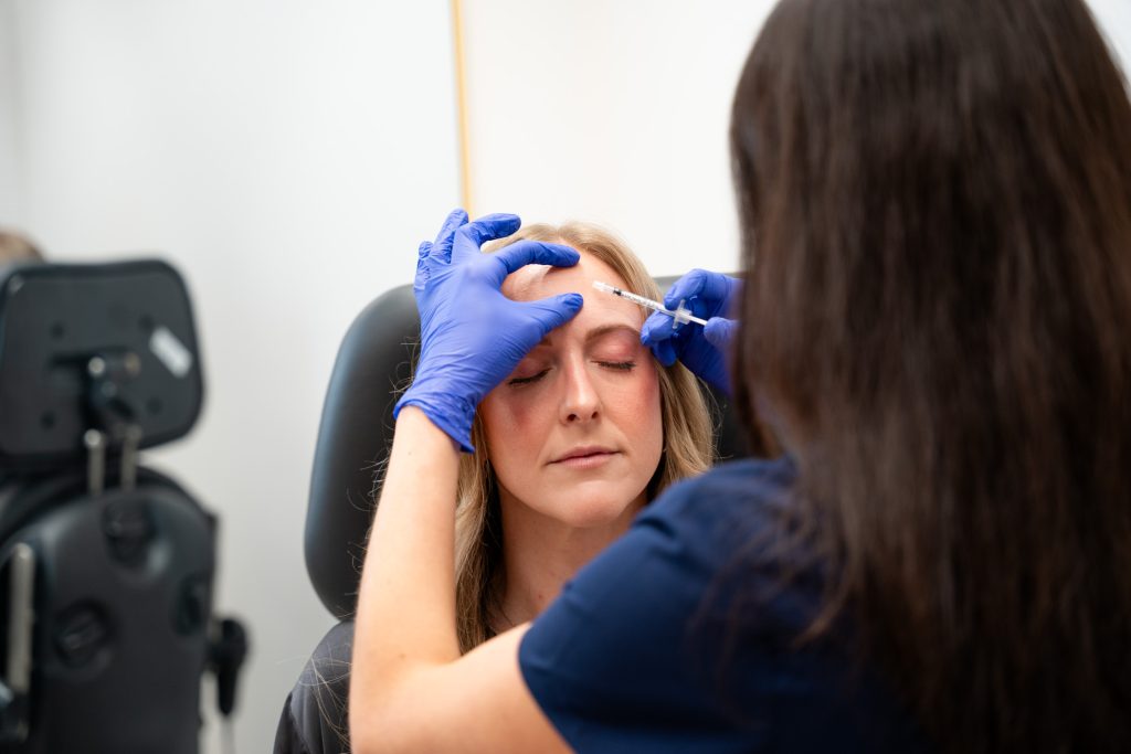 Provider giving dermal filler injection